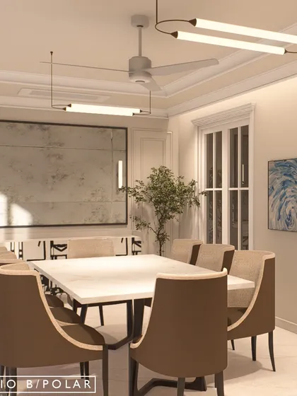 The formal dining room is defined by its clean lines, neutral palette, and modern lighting. A large, distressed mirror adds a sense of scale and reflects light, making the space feel bright and open.