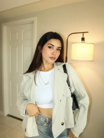 A more serious, fashion-focused pose in the same indoor setting.