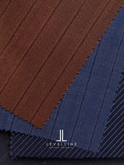 A selection of pinstripe and herringbone fabrics in brown and blue from Holland & Sherry, perfect for a distinguished suit.