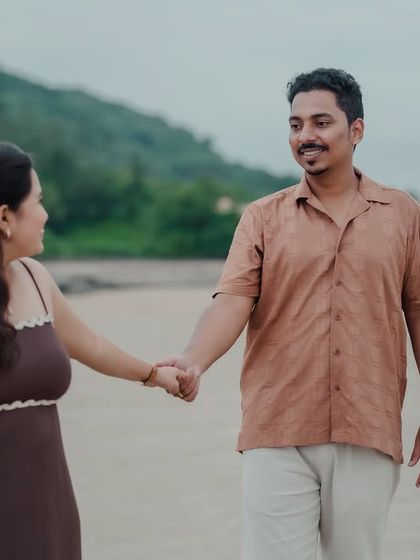A candid walking shot where the couple shares a look and a smile. This photo captures the easy, natural flow of their conversation and connection.