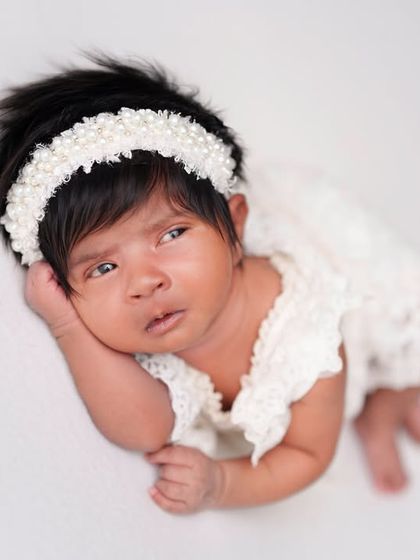 A beautiful, expressive portrait of an awake baby on a clean white background. This minimalist style keeps all the focus on your little one.