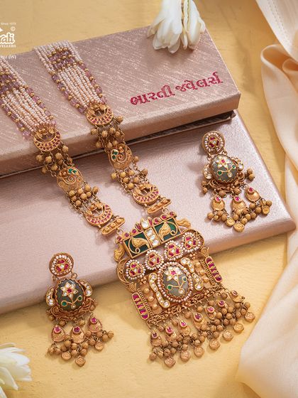 The Maharani Haar, presented in its entirety with matching earrings. This queenly adornment is defined by its grand silhouette, intricate detailing, and strands of lustrous pearls, designed to command reverence and admiration.