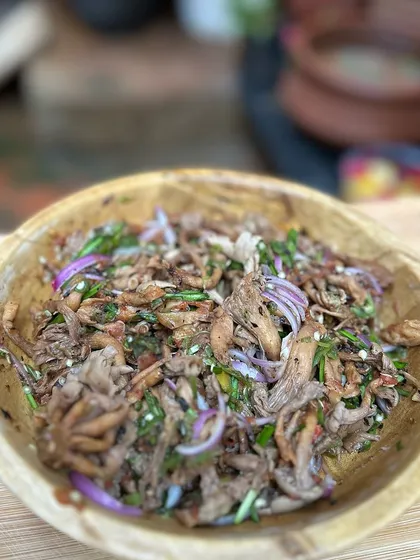 The oyster mushroom chutney served in a traditional wooden bowl. The simple preparation really lets the flavour of the mushrooms shine.