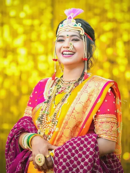 A vibrant and joyful portrait of a bride in her colorful Haldi or wedding attire. The bright yellow background makes her stand out beautifully.
