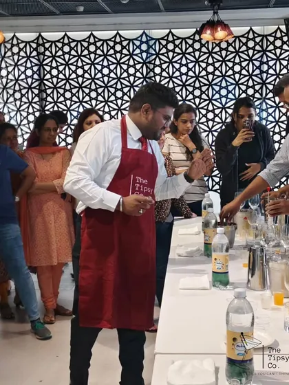Our instructor guides a guest through the steps of building a cocktail during a corporate workshop. We provide personal attention to ensure everyone learns and has a great time.