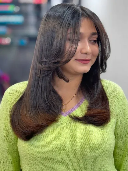 Self love is the best love, starting with your hair. This layered cut with curtain bangs is chic and stylish.