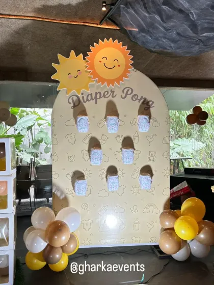 Fun and games for a baby shower! This custom "Diaper Pong" game board is a playful addition to the celebration, matching the "Ray of Sunshine" theme.