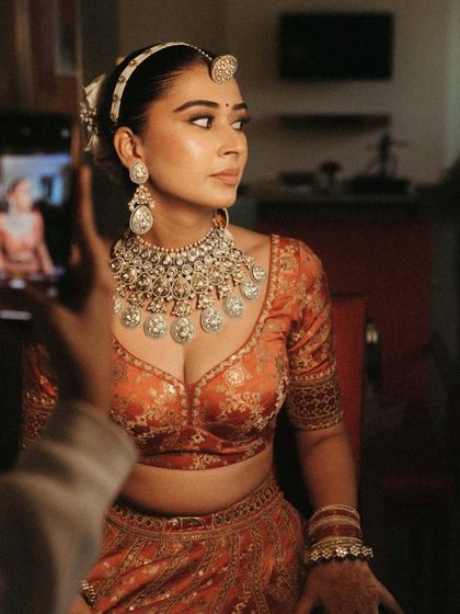 It's all in the details. A candid shot during the getting ready process, capturing the bride's anticipation.