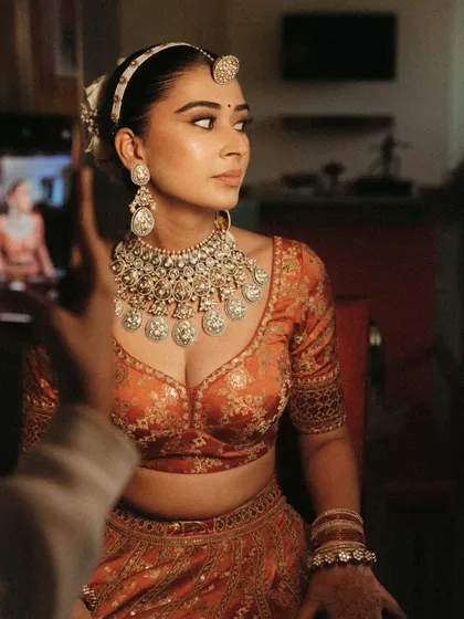 It's all in the details. A candid shot during the getting ready process, capturing the bride's anticipation.