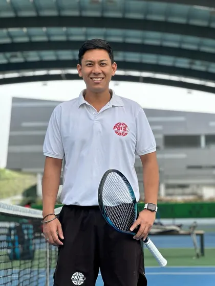 A portrait of our Head Coach, Rituplawan Gogoi, on the court. As a PBI Larry Huebner Humanitarian Award recipient, he leads our academy with a deep commitment to community service and athlete development.