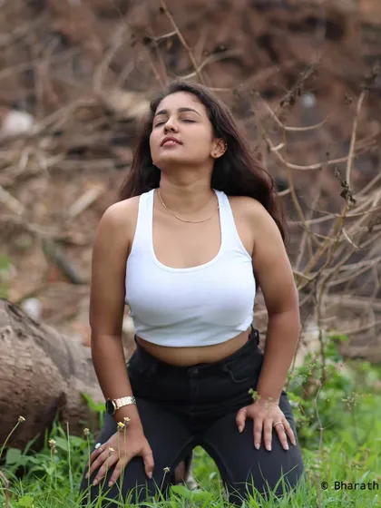 A candid, expressive shot of the model looking up, enjoying the natural surroundings.