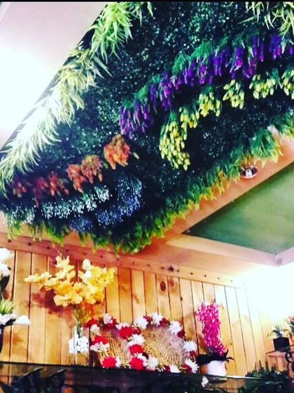 I created a large rectangular panel of artificial greenery and flowers to install on this ceiling. It completely transforms the look of the room from above and hides any imperfections on the ceiling.
