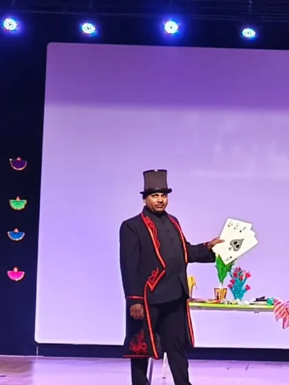 Performing a card trick on a formal stage. My show is scalable and can be adapted for larger events and auditoriums as well as smaller parties.