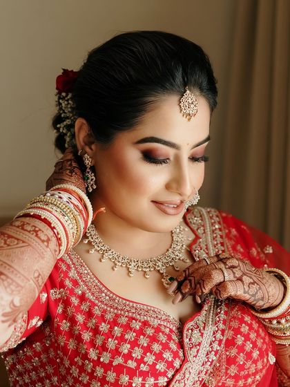 A close-up of Sakshi's makeup. The soft smoky eye adds depth and definition, while the skin remains fresh and glowing, a signature of my bridal style.