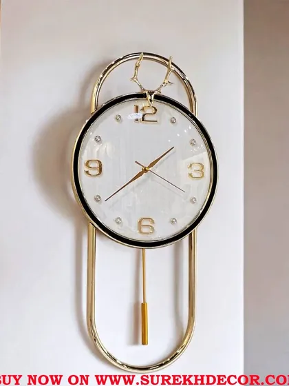 Classic and clean, this imported pendulum clock features a bright white face for easy readability. The simple yet elegant design, complete with a deer-head accent, makes it a versatile piece that complements any decor style.
