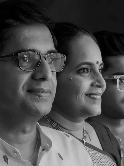 A creative and modern black and white portrait for a 25th anniversary, showing three profiles of the family lined up.
