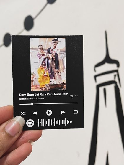 A traditional wedding photo made into a Spotify card with a devotional song, "Ram Ram Jai Raja Ram."