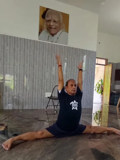 My personal practice of Hanumanasana (the splits) at the shala, under the watchful eye of my Guruji's portrait. A dedicated self-practice is the foundation from which I teach.