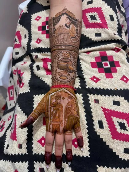 This full-hand design combines multiple wedding scenes. The palm features a varmala ceremony portrait, while the arm depicts a bride in her doli and other traditional wedding symbols.
