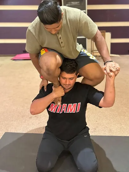 A standing Acro Yoga pose that requires balance and strength from both partners. This is a great example of building trust.