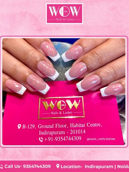 A beautiful example of a glitter French manicure. This look combines a soft pink, shimmery base with a classic white tip for a touch of glamour.