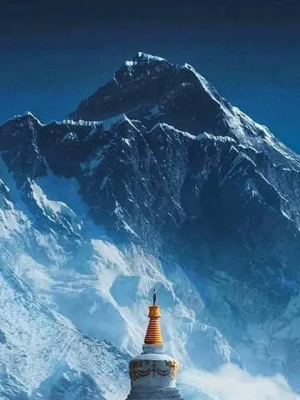 A Buddhist stupa stands against the backdrop of the mighty Himalayas on the Everest trail. The trek is a blend of natural beauty and rich Sherpa culture.