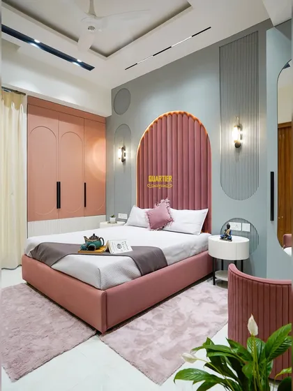 Designing for the younger members of the family is always a joy. This daughter's bedroom in Indirapuram features a stunning arched, channel-tufted headboard in rose pink, paired with soft grey walls and custom curved wardrobes, creating a space that is playful, chic, and timeless.