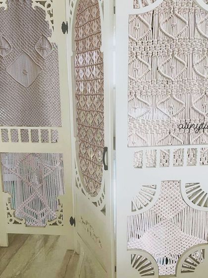 A closer look at the different macramé patterns woven into the custom room divider. Each panel was designed to be unique yet cohesive, adding texture and a vintage-modern feel to the space.