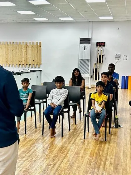 Young shooters listening attentively during an inspirational talk. We believe in exposing our students to diverse perspectives to help them grow as athletes and individuals.