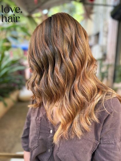 We call this one molten lava. A fiery bronde balayage with warm, golden, and copper tones that create a vibrant and high-energy look.