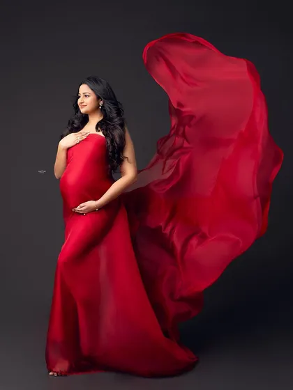 This shot captures the fabric in mid-air, creating a sense of energy and life. Mastering the fabric toss is a skill that will elevate your maternity photography.