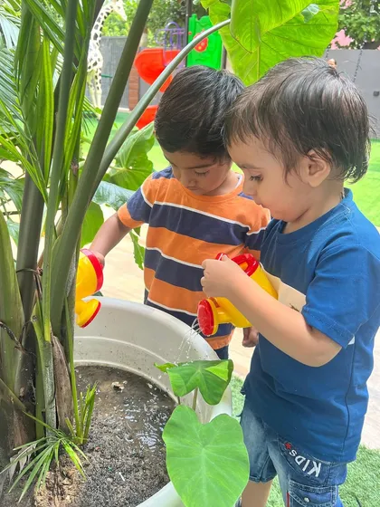Teamwork in the garden. These two boys are focused on their task, learning to cooperate while taking care of our school's green spaces.