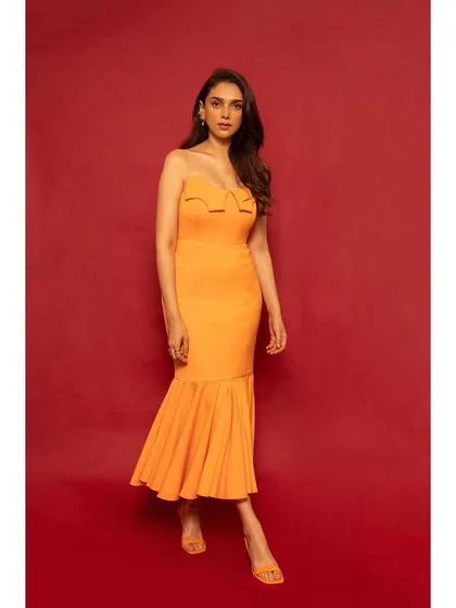 A full-length view of the orange mermaid dress, showing its unique silhouette and vibrant hue.