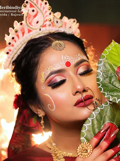 Our bridal training includes creating cohesive looks, like these traditional red nails that perfectly complement the classic Bengali bride makeup and attire.