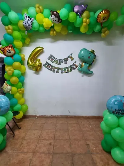Here's how I can transform an entryway into a wild adventure. This jungle-themed balloon arch is filled with cute animal foil balloons, setting a fun tone right as guests arrive for a 4th birthday celebration.