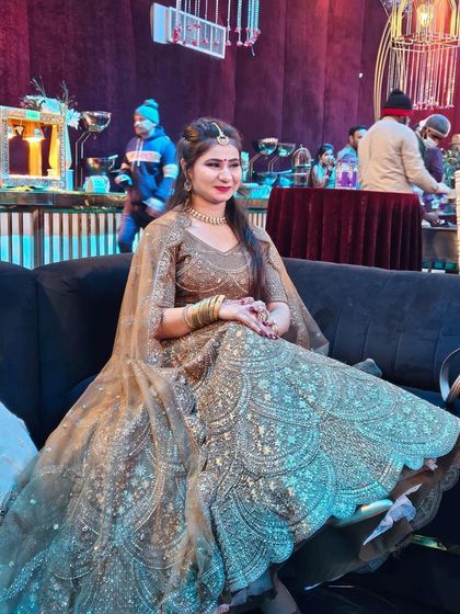 Comfort and style at a wedding function. This client is relaxing in a beautiful golden-brown rental lehenga, showing that you can look glamorous without being uncomfortable.