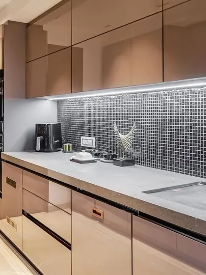 The sink area of the parallel acrylic kitchen, featuring an under-mount sink and modern faucet.