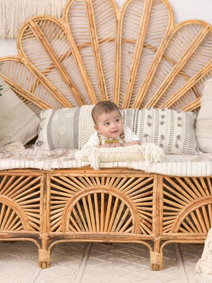 A baby boy enjoying the comfort of the boho-style rattan sofa. This shot highlights the beautiful and unique props available in my studio.