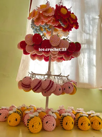 Another angle of my keychain collection, showing the different tiers of flower, strawberry, and bee charms ready for a bulk order.