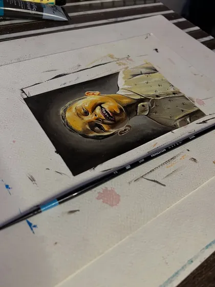 The portrait on my desk. I use fine brushes to paint these miniature pieces with as much realism as possible.