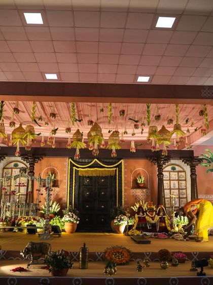 This shot captures the full expanse of the traditional stage we designed. Every element, from the carved wooden pillars to the brass artifacts, was carefully chosen to contribute to the nostalgic and culturally rich atmosphere.