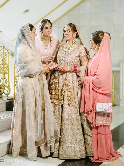 A beautiful moment between the bride and her family on the grand staircase during her Anand Karaj ceremony in Bangkok.