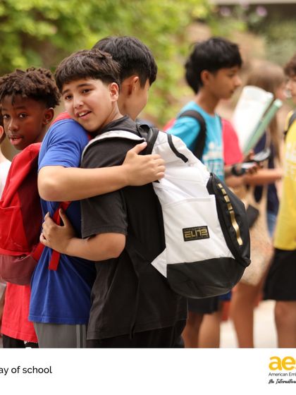 Students share a hug on the last day of school. The friendships formed at AES are deep and lasting, built on shared experiences within our diverse and supportive international community.