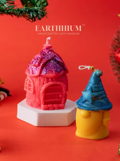 A festive set of two Christmas candles, a gnome and a little house, ready to be gifted.