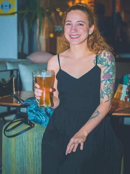 A guest enjoying a beer at the Christmas party.