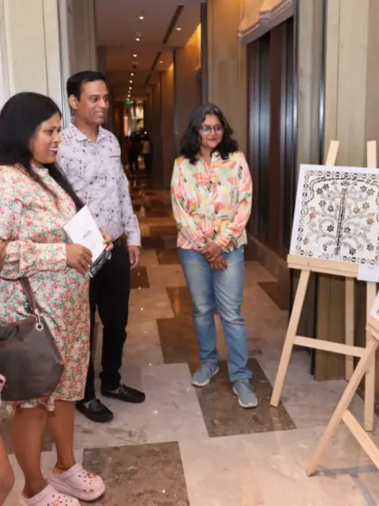 Artist Sreedevi with guests on the opening day of her 'Aaina' exhibition, showcasing her meticulous and creative mirror-work.