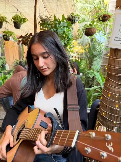 A talented guitarist setting the mood during our Women's Day event. The combination of live acoustic music and our natural ambiance creates an unforgettable experience.