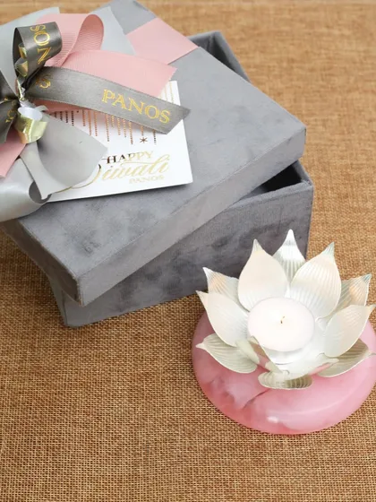 Another view of our silver-plated lotus diya, showcasing its beautiful form and the unique veining of the pink onyx base. Each piece is a unique work of art.