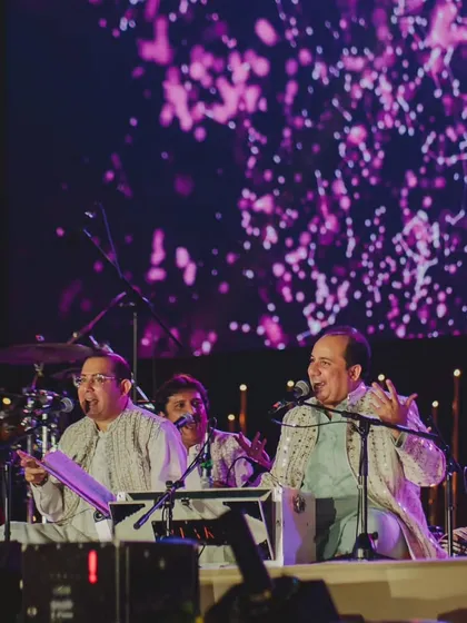 A wider view of Rahat Fateh Ali Khan's performance, showing the scale of the production. We manage everything to ensure a world-class entertainment experience for our clients.