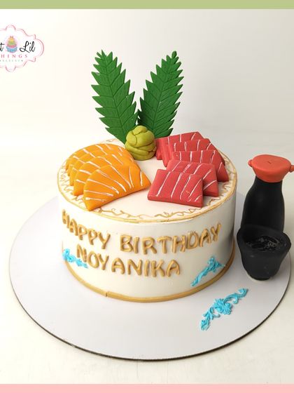 For the sushi lover who has everything! This unique cake is designed to look like a platter of sushi, complete with fondant salmon, tuna, wasabi, and soy sauce.